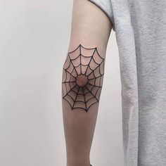 a person with a spider web tattoo on their arm