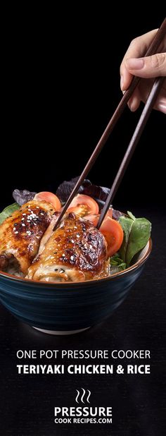 a person holding chopsticks over a bowl of food with meat and veggies