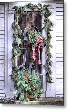 a door decorated with christmas wreaths and letters