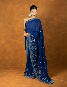 ABOUT THE SAREE Material :   Chiffon Color : navy blue Blouse :  will be custom made on request Saree border:  cutwork with embroidery  Pallu : cutwork embroidery and tassels Pico :  done Petticoat : can be procured for an extra cost Blouse length :  0.85 meters or as required Saree length :  5.5 meters (6yards) Wash Instructions.  Dry cleaving only Flaunt your style without compromising on authenticity. Premium sarees for all occasions. What you'll get? Handmade work, carefully curated silk thr Blue Pre-draped Saree With Chikankari Embroidery, Embroidered Blue Pre-draped Saree For Diwali, Blue Chikankari Embroidered Georgette Fabric, Blue Blouse With Chikankari Embroidery For Navratri, Blue Semi-stitched Pre-draped Saree With Chikankari Embroidery, Blue Unstitched Pre-draped Saree With Chikankari Embroidery, Blue Chikankari Embroidery Blouse For Navratri, Blue Saree With Resham Embroidery In Traditional Drape, Blue Saree With Resham Embroidery