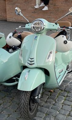 a light blue scooter parked on the street