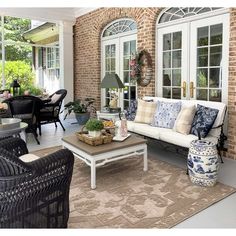 an outdoor living room with wicker furniture