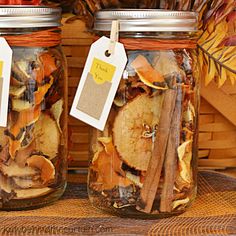 two jars filled with dried apples and cinnamons