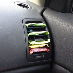 the interior of a car with food in it's holder on the dash board