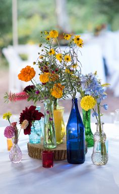 several vases filled with colorful flowers on top of a table