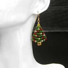 Quality-crafted using: > Bicone Shaped Crystals - Red, Green, Gold - 3mm > Hematite Gold Beads - 3mm > German Style Gold Wire > 14k Gold Plated Solid 925 Sterling Silver (stamped) Ear Wires Lightweight - Hypoallergenic - Nickel Free - Durable    🎄 Christmas Tree Earrings 🎄 Height:      1 1/2 inches  (37.5mm) Width:        1 inch  (25mm) Drop Length:  2 inches  (5cm) ❤️ Earrings are shipped with a pair of very comfortable, easy to use, silicone push backs.  Hypoallergenic - Non-Latex - Great for sensitive skin EAR WIRE INFORMATION: 14k Gold Plated Solid 925 Sterling Silver (Stamped) Ball Dot Fish Earring Hooks.  Sterling Silver and Gold are hypoallergenic and nickel free - a great choice for those who have sensitive skin ✦  All my sterling silver ear wires are coated with a clear protecti Tree Earrings, Christmas Tree Earrings, Earring Tree, Gold Wire, Gold Beads, Ear Wires, Solid 925 Sterling Silver, Jewelry Earrings Dangle, Dangle Drop Earrings