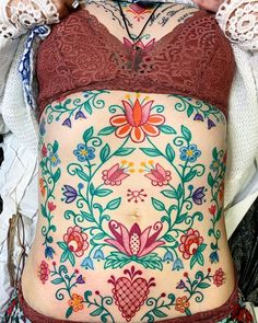 a woman with tattoos on her stomach