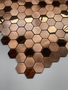 a close up view of a metal hexagonal tile design on the wall in an office building