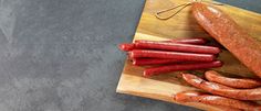 hot dogs and sausages on a cutting board