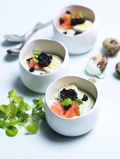 three small bowls filled with food on top of a table