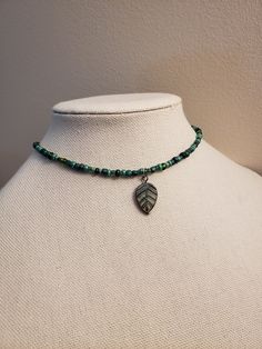 A beaded choker made of various shades of green glass beads and a glass leaf charm that has a bronze tone.  The beaded part of necklace is 14in and has a 2in extending chain. The beads are do not follow a specific pattern so they will vary with each necklace. Green Czech Glass Beaded Necklace With Dangling Beads, Earthy Necklace, Earthy Jewelry, Green Beaded Necklace, Saint Michael, Hippie Necklace, Funky Jewelry, Jewelry Lookbook, Forest Fairy