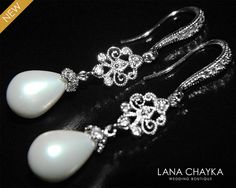 White Teardrop Pearl Chandelier Earrings Dangle by LanaChayka White Gold Chandelier Earrings For Wedding, Classic Wedding Chandelier Earrings With Diamond Accents, White Diamond Accents Chandelier Earrings For Wedding, White Gold Teardrop Chandelier Earrings For Wedding, Elegant White Jewelry For Wedding Reception, White Hand-set Pearl Earrings For Wedding, Hand-set White Pearl Earrings For Wedding, White Hand Set Pearl Earrings For Wedding, Intricate Drop Earrings For Wedding