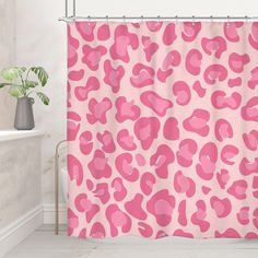 a pink shower curtain with hearts on it