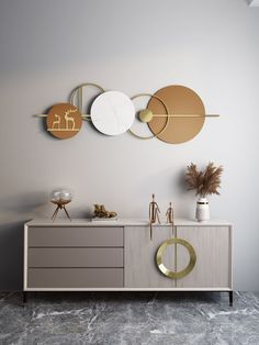 a white and gold bathroom with three circular mirrors on the wall next to a sink