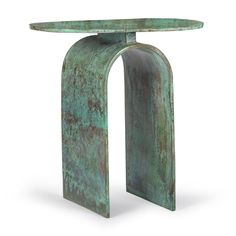 a green metal table with an arched top