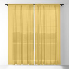 a yellow curtain hanging in front of a white wall