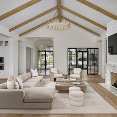 a living room filled with furniture and a flat screen tv mounted on a wall above a fireplace