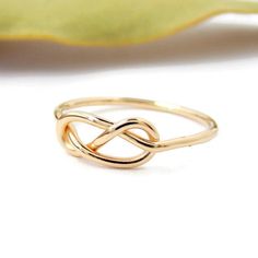 This Infinity Knot Ring is a dainty and classic ring. It's a great gift for that special someone. -14K Solid Gold -Infinity Knot Ring -Band just over 1mm thick This ring is a great gift for many occasions. It is dainty and delicate yet classic and sturdy. Each ring is handcrafted just for you and treated with care. This ring comes in your choice of Yellow Gold, White Gold, or Rose Gold (Pink Gold). Each ring comes packaged in a Ring Box ready for gift giving. It will be shipped via Priority Mail Infinity Shape Fine Jewelry Ring As Gift, Fine Jewelry Infinity Ring As Gift, Infinity Style Fine Jewelry Ring For Gift, Classic Infinity Rings As A Gift, Classic Infinity Rings As Gift, Classic Infinity Ring As A Gift, Classic Infinity Ring As Gift, Sterling Silver Infinity Ring In Yellow Gold, Elegant Infinity Ring As Gift