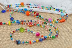 "This bohemian style necklace is full of every color in the rainbow! Each necklace is a varied mix of tiny glass seed beads, small czech beads, crystal beads, milifiori beads, small lampwork beads and so much more! This necklace is finished off with an antique silver plated toggle clasp making it super easy to wrap this necklace however you like. No two necklaces are exactly alike, though very similar, each one has it's own mix of beads making every necklace completely unique. Total length of th Handwoven Necklace, Champagne Earrings, Multi Coloured Necklaces, Boho Wrap Bracelet, Colorful Necklace, Necklace Colorful, Wrap Necklace, Necklace Love, Handmade Beaded Necklaces