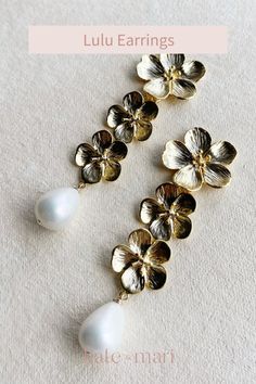 Our Lulu Earrings feature a triple flower and mother pearl drop. 14K gold plated flowers each measuring 1 inch (stud) and .7 inches wide. Total length of earrings: approx 2.75 inches long and 1 inch wide. Available in post stud or clip on (upon request). Gold Drop Earrings With 3d Flowers, Bridesmaid Gifts Jewelry, Flower Plates, Mother Pearl, Gifts For Wedding Party, Bridesmaid Jewelry, Pearl Drop, Elegant Jewelry, Wedding Earrings