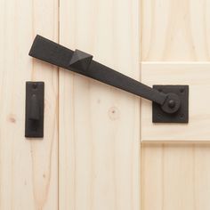 a black door handle on a wooden door