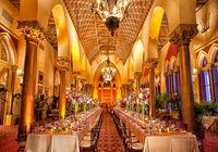 the inside of a large dining hall with tables and chairs set up for an event