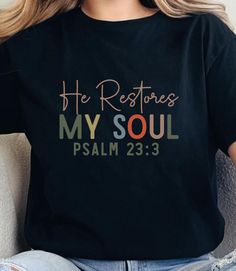 He Restores My Soul Tee, Adult Unisex Sizes XS Thru 5XL Lightweight Breathable Short Sleeve Shirt, Christian Tee Psalm 23:3. Standard Fit Unisex T-Shirt (Not A Fitted Women's Petite Style).  See Size & Fit Charts, Size Up For A Less Fitted, More Relaxed Fit.  All Shirts Are Made With A Lightweight, Soft, Breathable Fabric.  Fabric Content: Black: 100% Cotton.  White: 100% Cotton.  Care Instructions:  Spot Treat With Stain Remover If Necessary.  Turn Garment Inside Out Before Washing. Wash Inside Out on Cold & Gentle Cycle.  Do Not Bleach. Hang Dry or Tumble Dry Low. Low Iron if Necessary. Do Not Iron Over Design.  Do Not Dry Clean. We want you to be 100% happy with your order. If your order is damaged or incorrect,  please send us a photo & we will make it right for you. We do not do excha Psalm 23 3, He Restores My Soul, Petite Style, Christian Tees, Psalm 23, Low Low, Low Iron, Christian Shirts, Petite Fashion