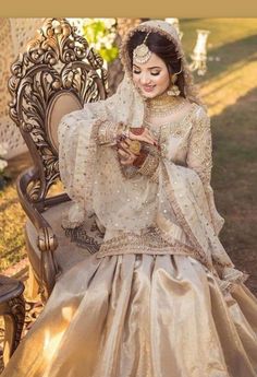 a woman sitting on top of a chair in a dress