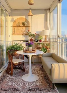 a living room filled with furniture and lots of plants on top of a rug in front of a window