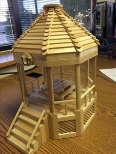 an image of a wooden gazebo with stairs on the front and bottom sides, in 3d