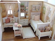 a doll house with furniture and accessories in the living room, including two twin beds