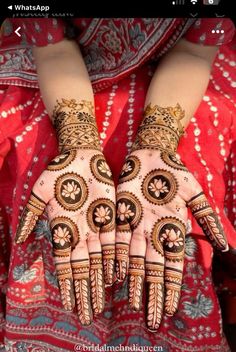 a woman's hands decorated with hennap