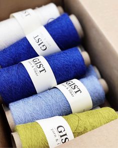 four spools of thread in a box