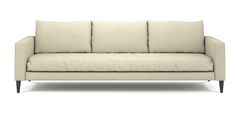 a white couch sitting on top of a wooden frame