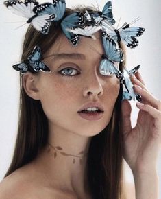 a woman with blue butterflies on her head