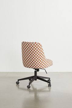 an orange and white checkerboard office chair on castors with casteor wheels