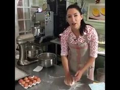 a woman is making food in the kitchen