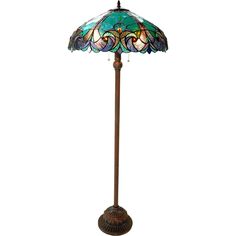 a stained glass floor lamp on a wooden base with an ornate design in the center