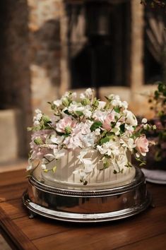 a white cake with pink and white flowers on top