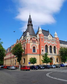 an old building with cars parked in front