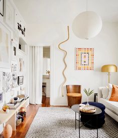 a living room filled with furniture and pictures on the wall