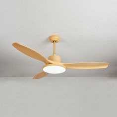 a ceiling fan in a room with white walls and light fixtures on the ceiling,