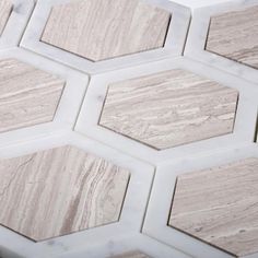 some white and brown marble tiles with hexagons on them in a pattern