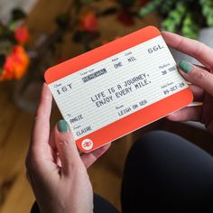 a person holding up a ticket for a concert