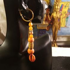 Chic Small Top Gold Tone Latch Backs Hoops With Bottom Orange Beaded Lucite Beads, Orange Wood Beads And Bottom Orange Painted Cowrie Shells Earrings. Earrings Are 3 1/2. Inches In Length Light Weight And Not Heavy. Gold Tone Latch Back Ear Wires Are Hyproallegic Metal Lead Free/Nickle Free Ear Wires. Traditional Orange Jewelry For Beach, Traditional Orange Beach Jewelry, Orange Beaded Dangling Earrings For Beach, Orange Jewelry With Dangling Beads For Beach, Orange Beach Jewelry With Dangling Beads, Orange Beaded Earrings With Gold Round Beads, Orange Dangling Beads Earrings For Beach, Bohemian Orange Beaded Earrings For Beach, Traditional Orange Earrings For Beach