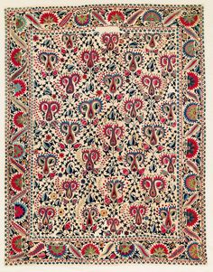 an intricately designed rug with red, blue and green designs on the bottom half