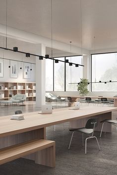 an empty conference room with wooden tables and chairs in front of large windows that look out onto the outdoors