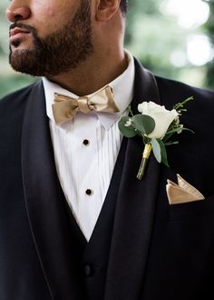 a man in a tuxedo with a boutonniere on his lapel