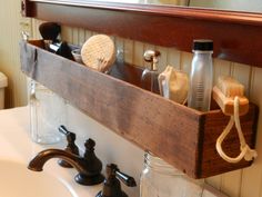 a bathroom sink with soap, toothbrushes and other items on the shelf above it