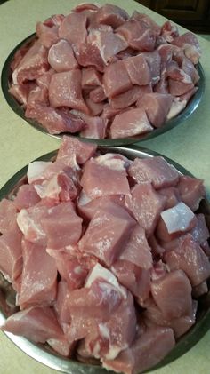 two plates filled with meat sitting on top of a table